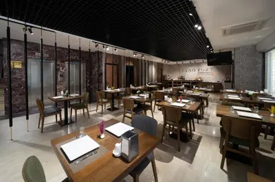 a restaurant with wooden tables and chairs in a room at Pianoforte by Febor Hotels&Spa in Istanbul