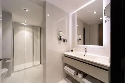 a white bathroom with a sink and a mirror at Pianoforte by Febor Hotels&Spa in Istanbul