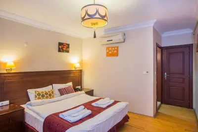 a bedroom with a bed with two towels on it at Berce Apartments in Istanbul