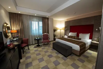 a hotel room with a bed and a desk and chair at Agaoğlu My City Hotel Istanbul in Istanbul