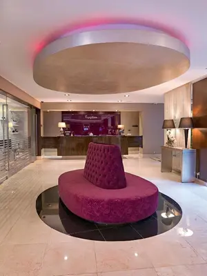 a large lobby with a purple chair in the middle at Agaoğlu My City Hotel Istanbul in Istanbul