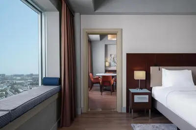 a hotel room with a bed and a table with chairs at Delta Hotels Istanbul West in Istanbul