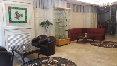a living room with a red couch and tables at Taksim Star Hotel in Istanbul