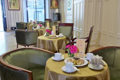 a restaurant with two tables with cups and plates of food at Taksim Star Hotel in Istanbul