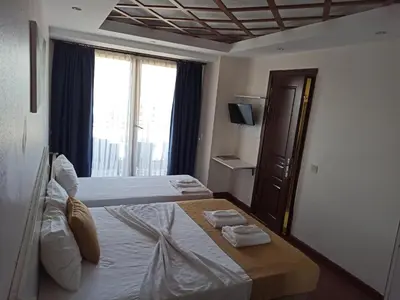 a bedroom with a bed with two towels on it at Buyukada Comfort OTEL in Buyukada