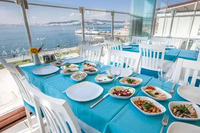 a blue table with plates of food on it at Buyukada Comfort OTEL in Buyukada