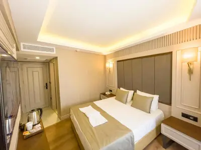 a bedroom with a large white bed in a room at Martinenz Hotel in Istanbul