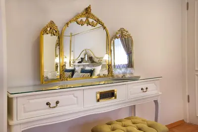 a dressing table with a mirror and a stool at Valide Sultan Konagi in Istanbul