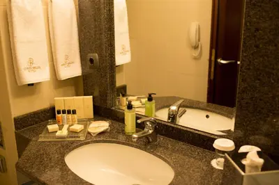 a bathroom counter with a sink and a tub at Germir Palas Hotel - Special Class in Istanbul