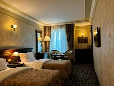a hotel room with two beds and a table at Germir Palas Hotel - Special Class in Istanbul