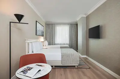 a hotel room with a bed and a table at Elite World Comfy Istanbul Taksim in Istanbul