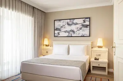 a bedroom with a bed and a picture on the wall at Elite World Comfy Istanbul Taksim in Istanbul