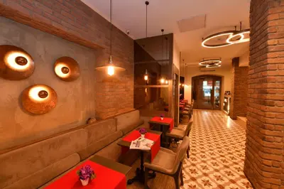 a restaurant with tables and chairs and brick walls at The Pera Hotel in Istanbul