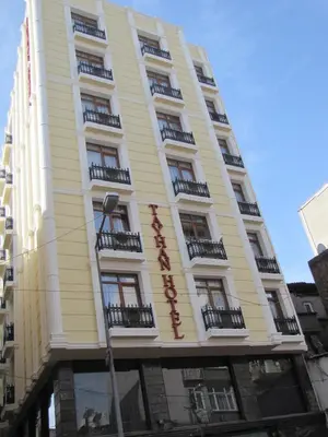 a yellow building with balconies on the side of it at Tayhan Hotel in Istanbul