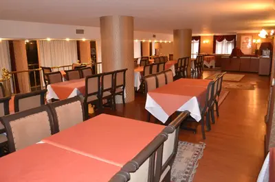 a restaurant with red tables and chairs and a couch at Tayhan Hotel in Istanbul