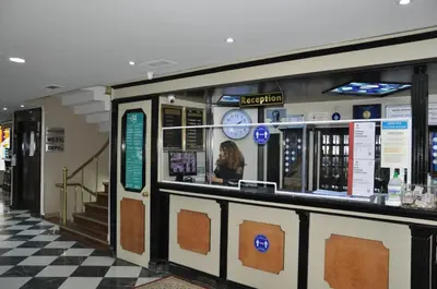 a woman sitting at a counter in a restaurant at Tayhan Hotel in Istanbul