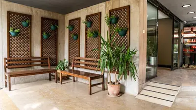 a lobby with benches and potted plants on the wall at The Marmara Suadiye Residence in Istanbul