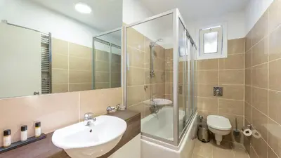 a bathroom with a sink and a toilet and a shower at The Marmara Suadiye Residence in Istanbul