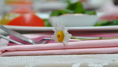 a flower on top of some pink napkins on a table at Kitapevi Hotel in Bursa