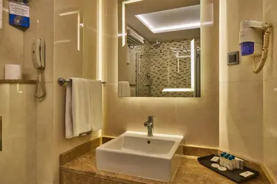 a bathroom with a sink and a mirror at Grand Hotel Gulsoy Old City in Istanbul