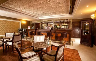 a restaurant with a bar with a man standing behind the bar at Grand Halic Goldenhorn in Istanbul