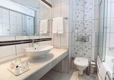 a white bathroom with a sink and a toilet at Grand Halic Goldenhorn in Istanbul