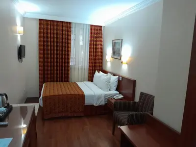 a hotel room with a bed and a chair at Grand Halic Goldenhorn in Istanbul
