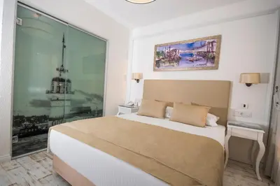 a bedroom with a bed and a large window at Antis Hotel-Special Category in Istanbul