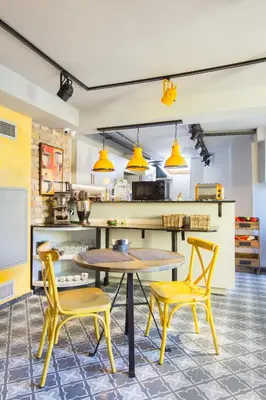 a kitchen with a table and two yellow chairs at Hotel Poem in Istanbul