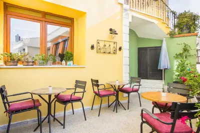 a patio with tables and chairs and an umbrella at Hotel Poem in Istanbul