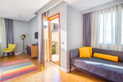 a living room with a couch and a window at Hotel Poem in Istanbul