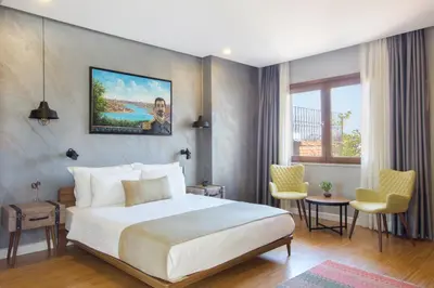 a hotel room with a bed and a table and chairs at Hotel Poem in Istanbul