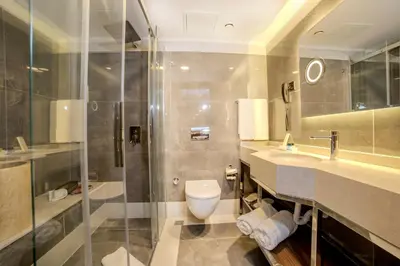 a bathroom with a toilet and a sink and a shower at Grand Hilarium Hotel in Istanbul