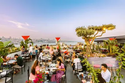 people sitting at tables on the roof of a restaurant at Seres Hotel Old City in Istanbul