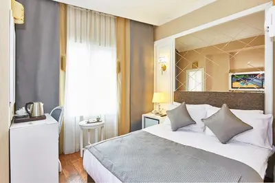a bedroom with a large bed with a large mirror at Seres Hotel Old City in Istanbul
