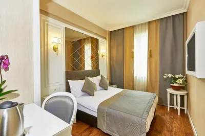 a hotel room with a bed and a table and chair at Seres Hotel Old City in Istanbul