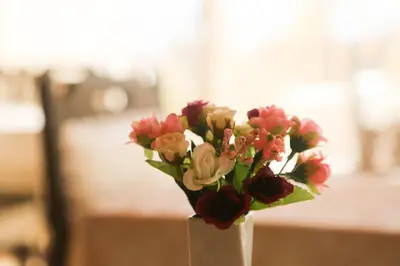 a white vase filled with flowers on a table at Theodian Hotel in Istanbul