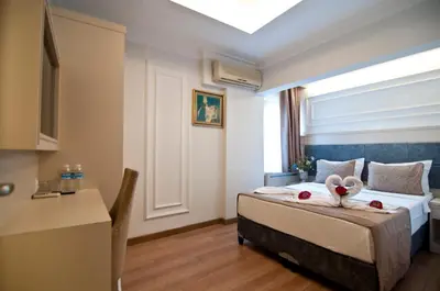 a bedroom with a bed with two swans on it at Royce Hotel in Istanbul