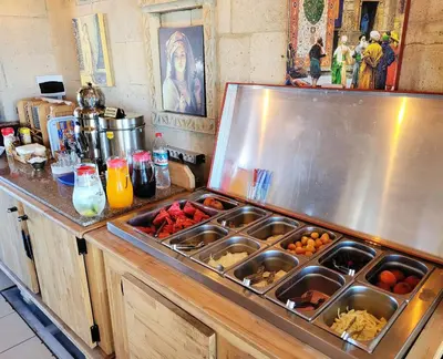 a kitchen counter with a sink with food in it at Saruhan Hotel in Istanbul