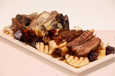a plate of meat and other food on a table at Baia Bursa Hotel in Bursa