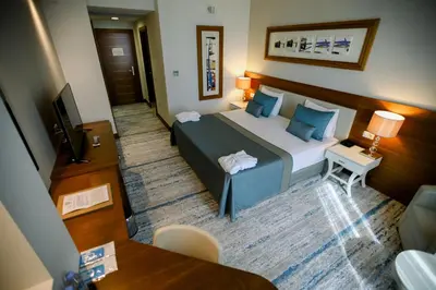 a bedroom with a bed with blue pillows at Baia Bursa Hotel in Bursa