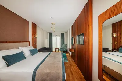a hotel room with a large bed and a desk at Triton Hotel in Istanbul