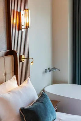 a bedroom with a tub and a bed with a pillow at Triton Hotel in Istanbul