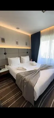 a large white bed in a room with a window at Cihangir Hotel Bosphorus in Istanbul