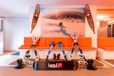 a set of skis and a snowboard in front of a couch at Monte Baia Uludağ in Uludag
