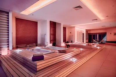 a large bathroom with two tubs and a wooden floor at Monte Baia Uludağ in Uludag