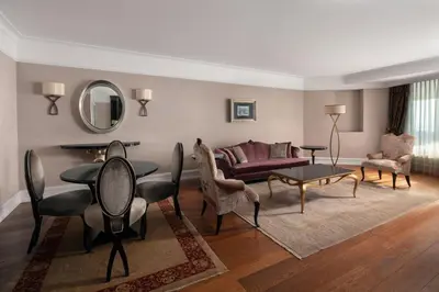 a living room with a couch and a table and chairs at Istanbul Marriott Hotel Pendik in Istanbul