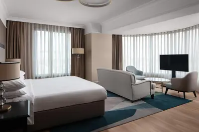 a hotel room with a bed and a chair at Istanbul Marriott Hotel Pendik in Istanbul
