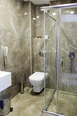 a bathroom with a toilet and a glass shower at Bucoleon by Cheers in Istanbul