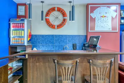 a bar in a restaurant with a clock on the wall at Fors Hotel in Istanbul